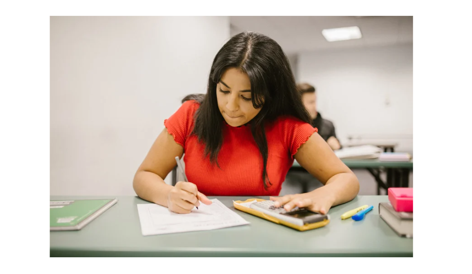 A girl writing maths exam