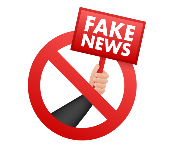 A red prohibition sign with a hand holding a red sign that reads "FAKE NEWS," symbolizing a warning against misinformation